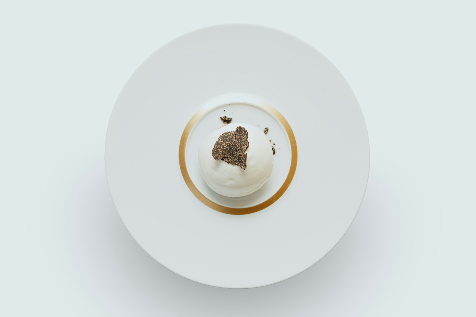 a white plate topped with a dessert on top of a white table